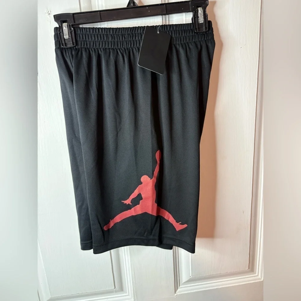 Red and black youth basketball Jordan shorts size 12-13